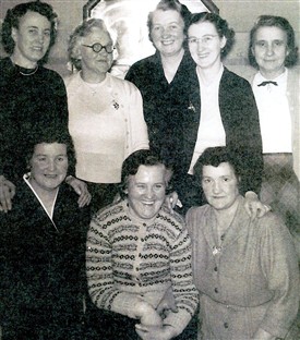 Photo:Community Club Committee, Addiewell, 1950s.  Back Row (L-R): Mrs Meg Muirhead, Mrs M. Corrigan, Mrs M. Kane, Mrs G. Lynch, Mrs McColl.  Front Row (L-R): Mrs Cameron, Mrs Scott, Mrs M. Brown.