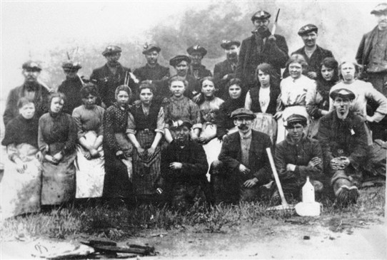 Photo:Miners, and women pithead workers at Loganlea Colliery, c. 1910s.  After women and children were banned from working underground in 1844, many continued to work on the surface.  It was tough, demanding work for the women.