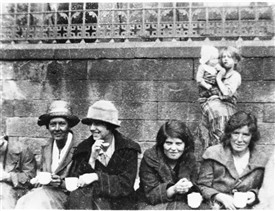 Photo:Women sitting outside the West Calder Parish Office (now the dental surgery across from Wood's garage).  They were protesting that the Parish Council had decided to cease payments to striking miners.
